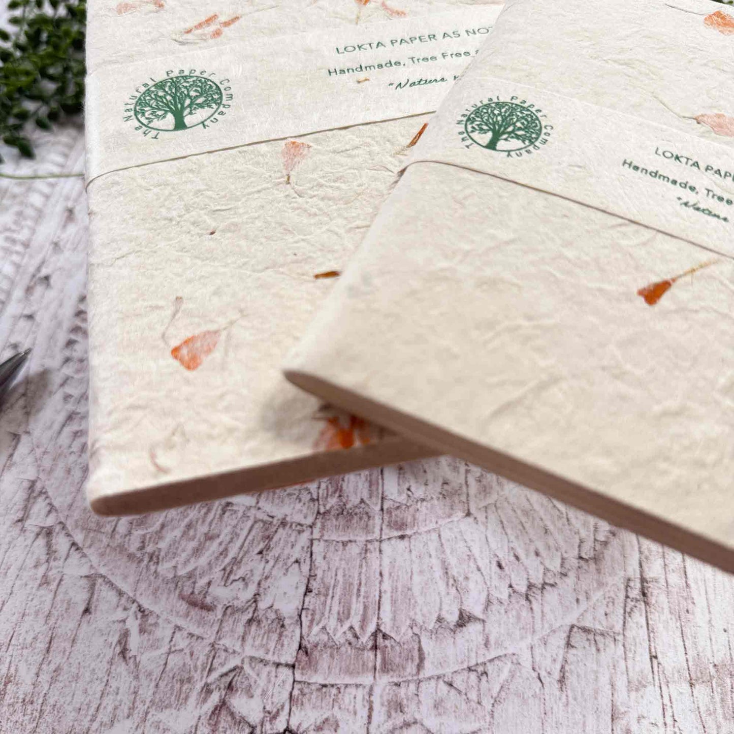 Detailed shot of A5 and A6 Marigold Lokta notebooks, highlighting paper thickness, texture, and brand labelling