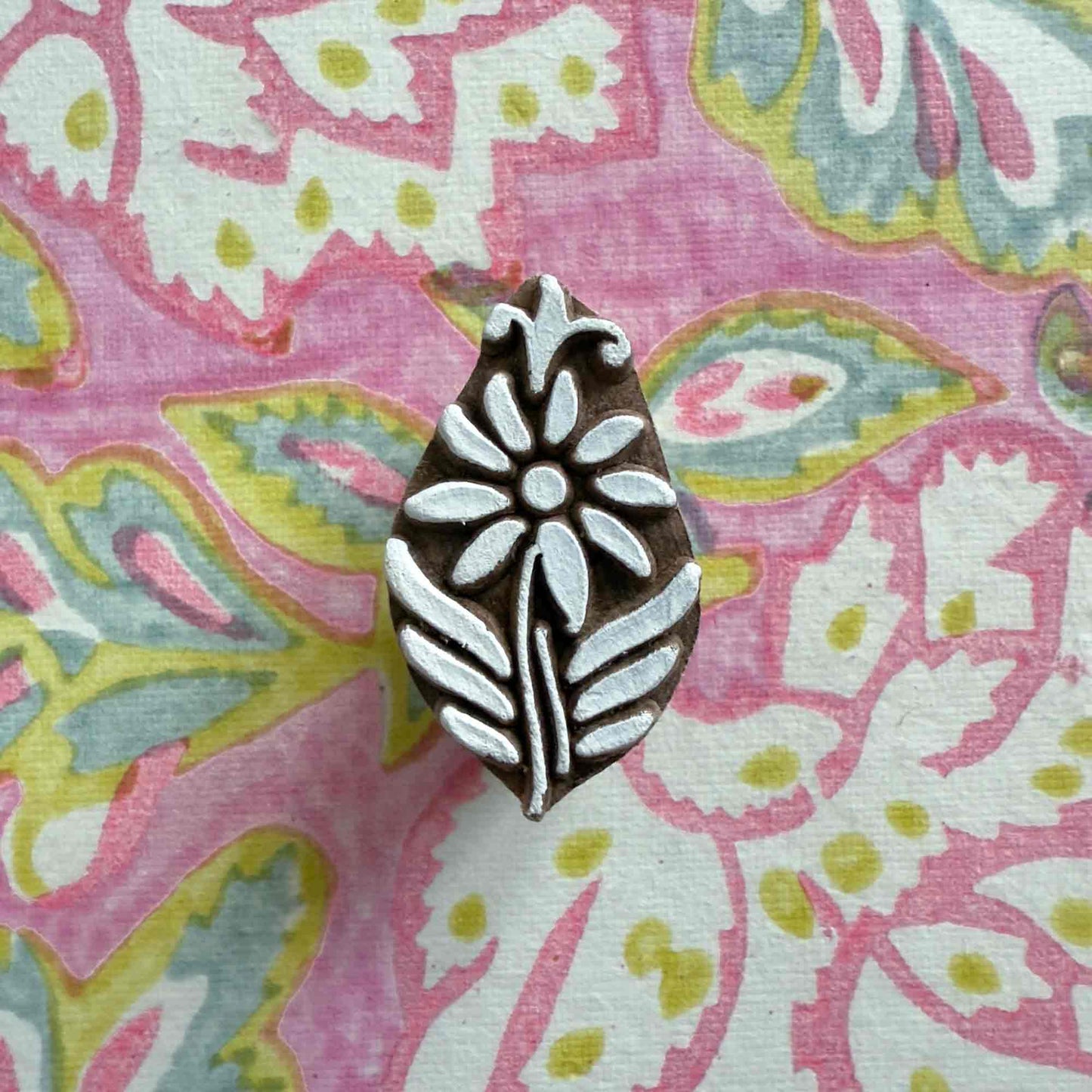 small wood block stamp with flower pattern.