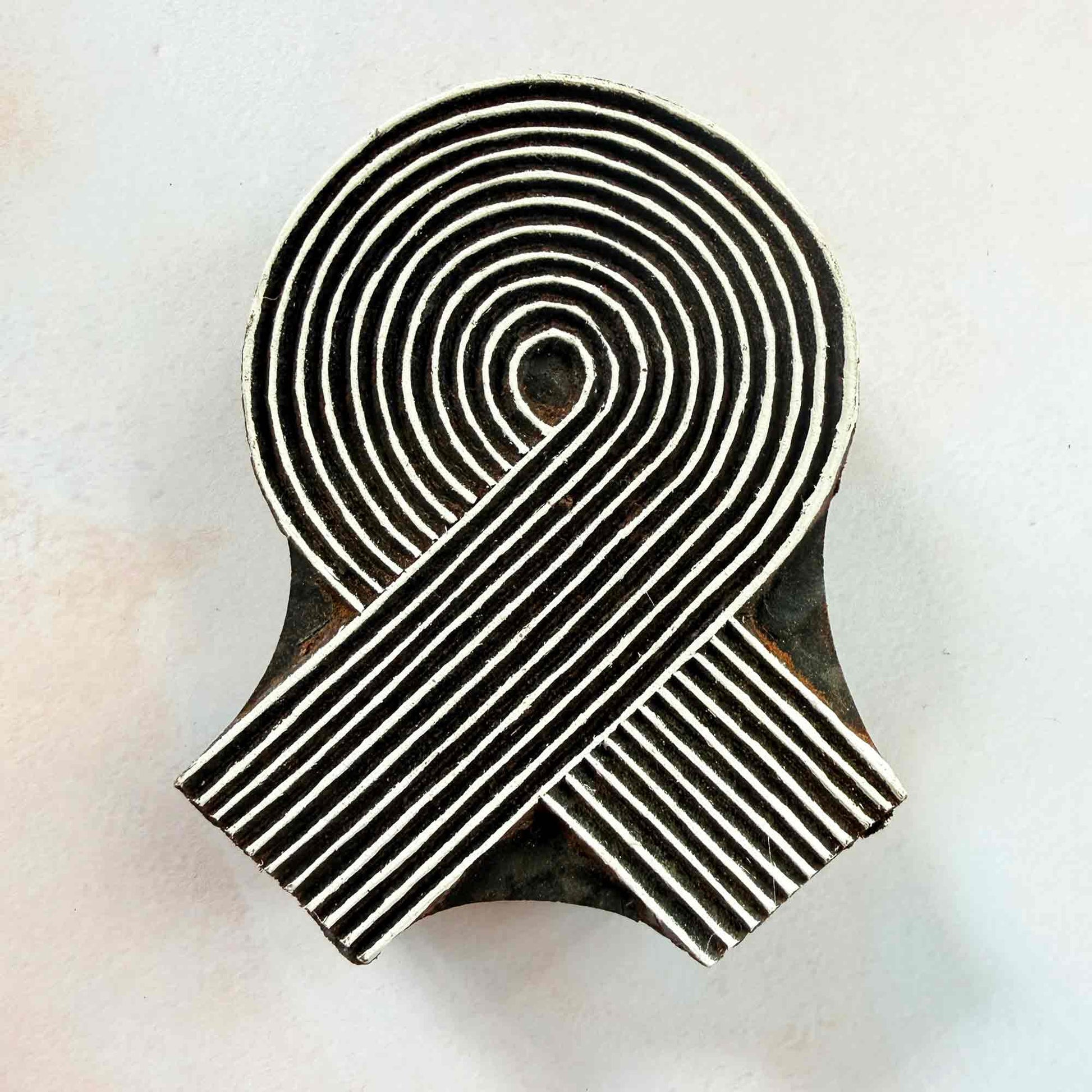 Swirl Indian wood block stamp — elegant spiral ribbon face-on view, hand-carved traditional printing block on neutral background
