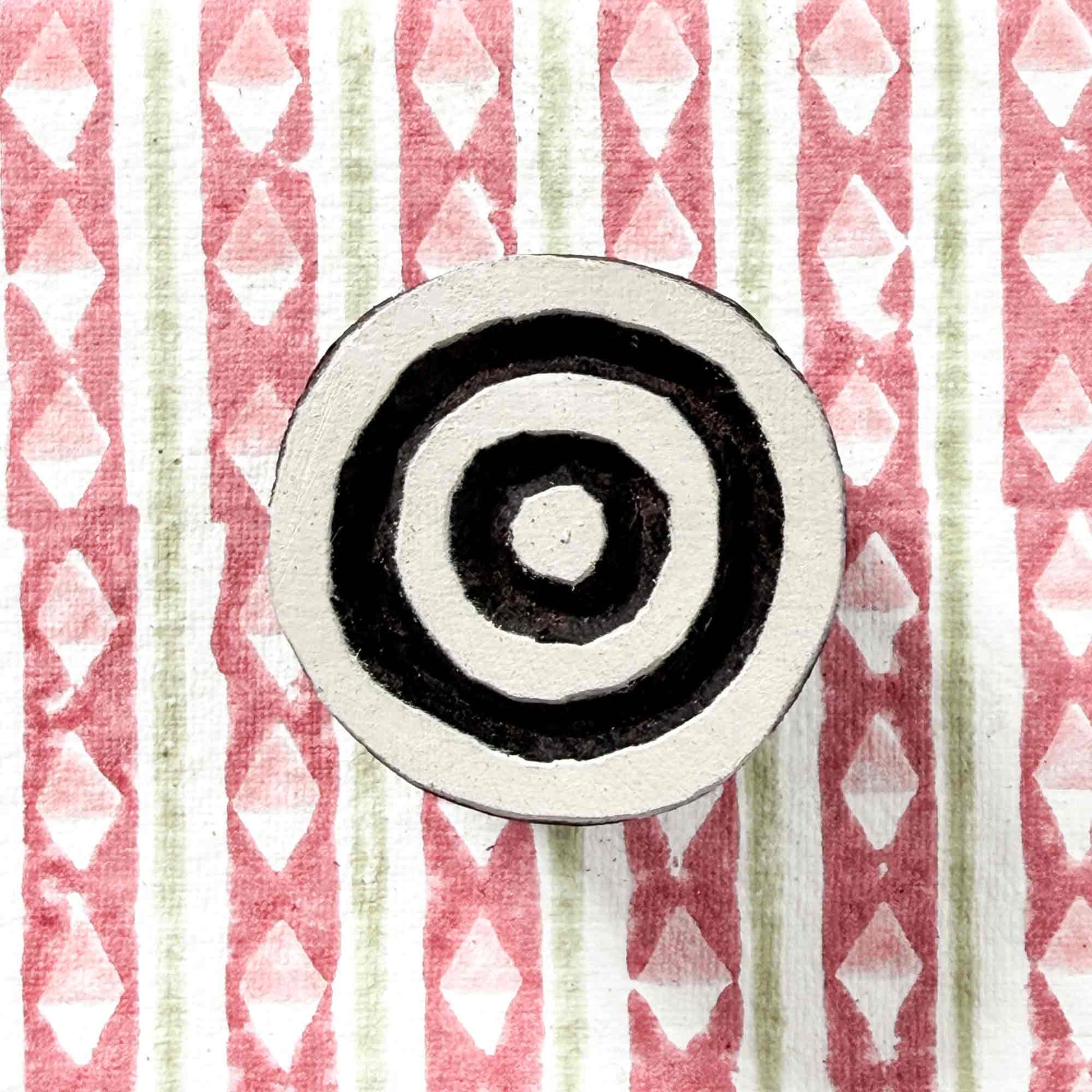 Indian wood block stamp — Target concentric circles face-on view on block printed background, symmetrical ring design, handcrafted wooden stamp, premium traditional printing block hardwood