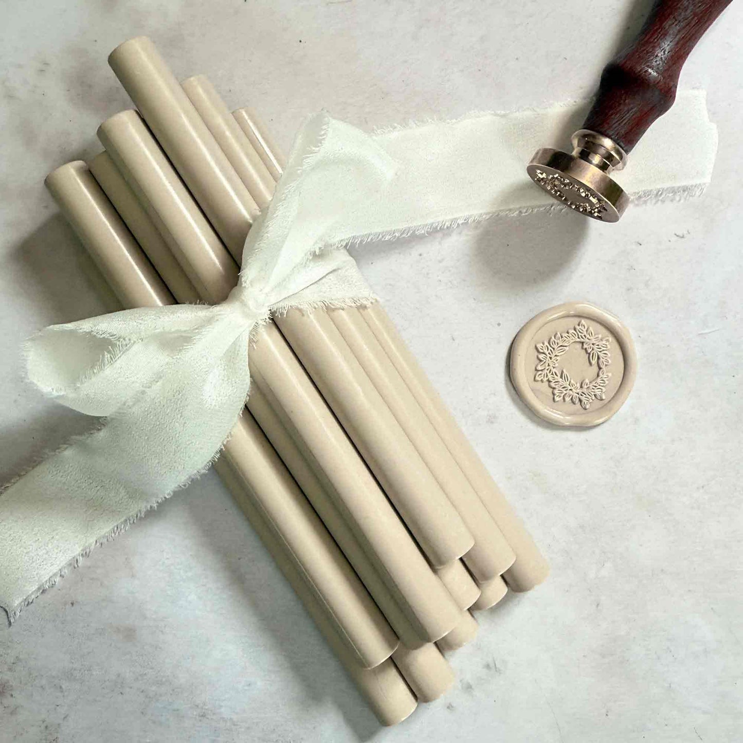 Sealing wax sticks to make taupe wax seals.  Glue gun sealing wax sticks in beige