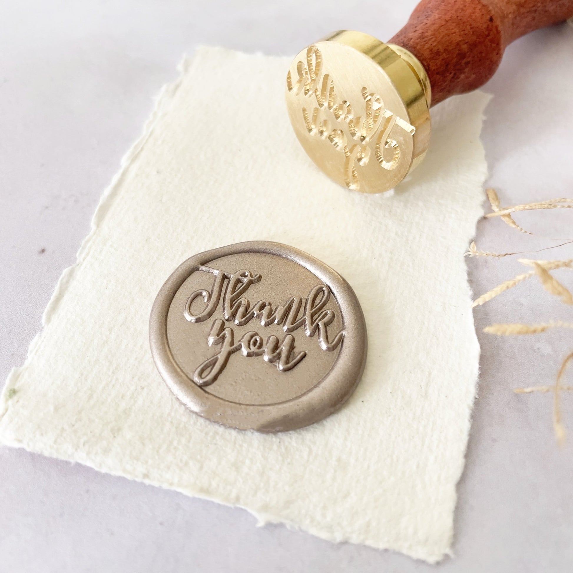 Thank you wax stamp for making wax seals.  Calligraphy style stamp with a brass head and wooden handle.  Perfect for adding wax wax seal to thank you cards, gift wrapping, corporate branding and lots more.  By The Natural Paper Company