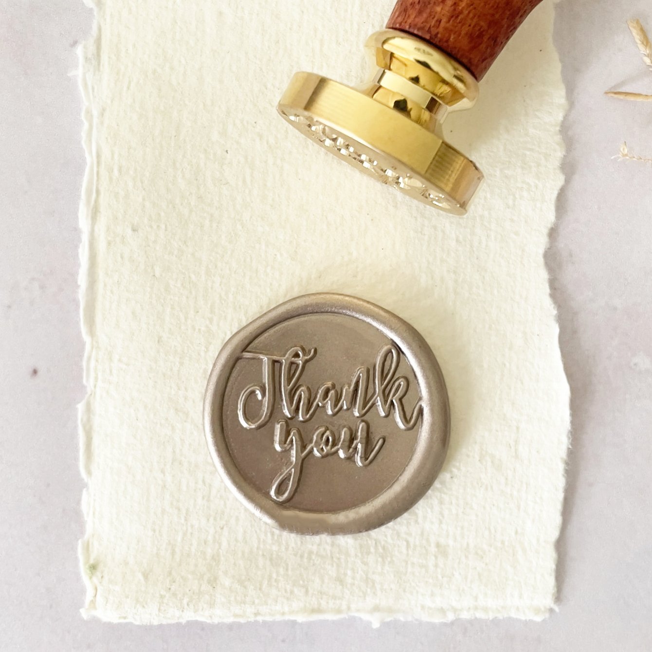 Thank You Calligraphy Style wax seal stamp with a brass head and wooden handle.  Wax stamp for making thank you cards, gift wrapping and decorating envelopes.  By The Natural Paper Company