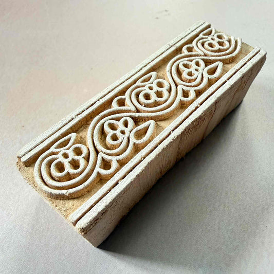 Wooden stamp with intricate floral carvings 