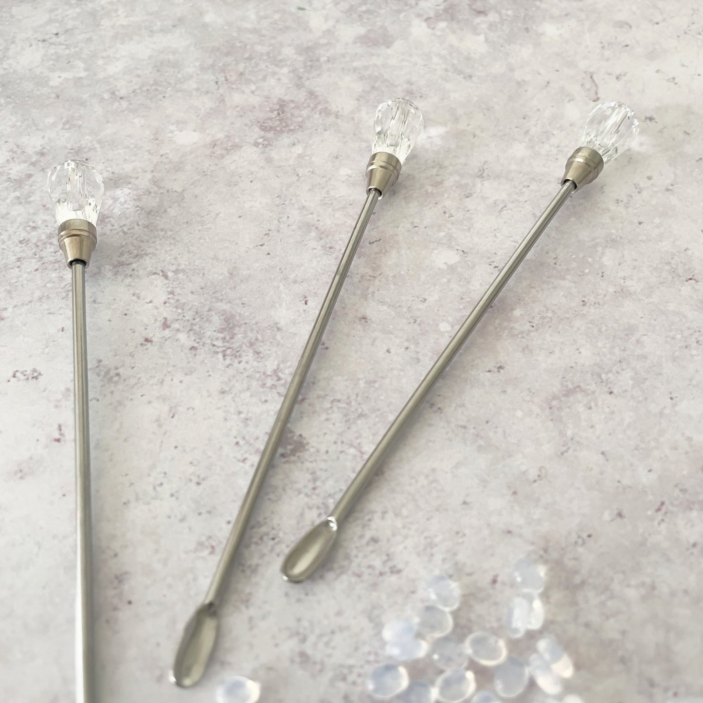 Small stirring spoon for wax.  Stirrer for making wax seals.  Tiny silver spoon with a crystal head.  By The Natural Paper Company