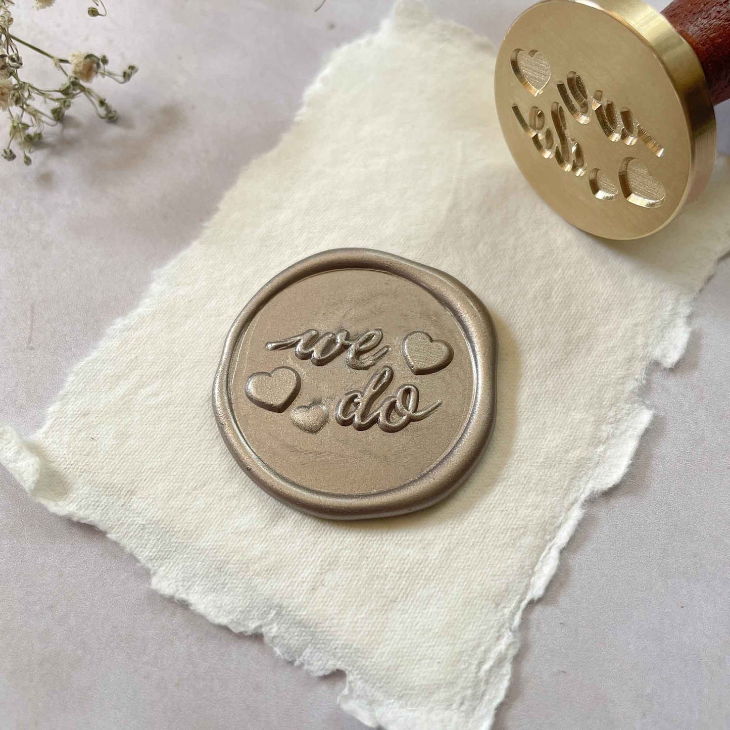 We Do wax seal stamp for weddings.  Calligraphy style sealing wax stamp with a hearts.  Use with your choice of eco friendly sealing wax to make the perfect wax seal for weddings.  By The Natural Paper Company