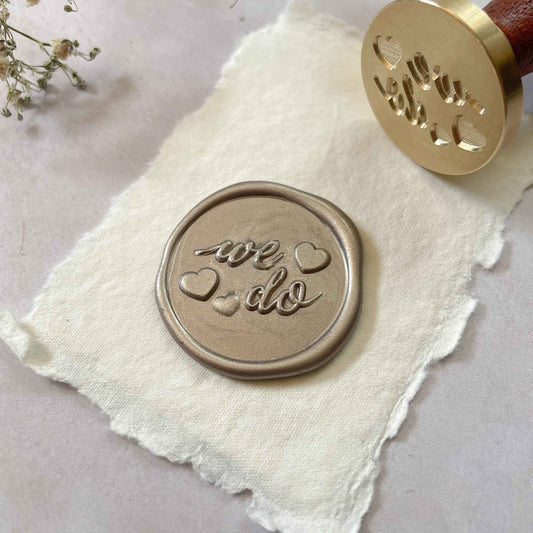 We Do wax seal stamp for weddings.  Calligraphy style sealing wax stamp with a hearts.  Use with your choice of eco friendly sealing wax to make the perfect wax seal for weddings.  By The Natural Paper Company