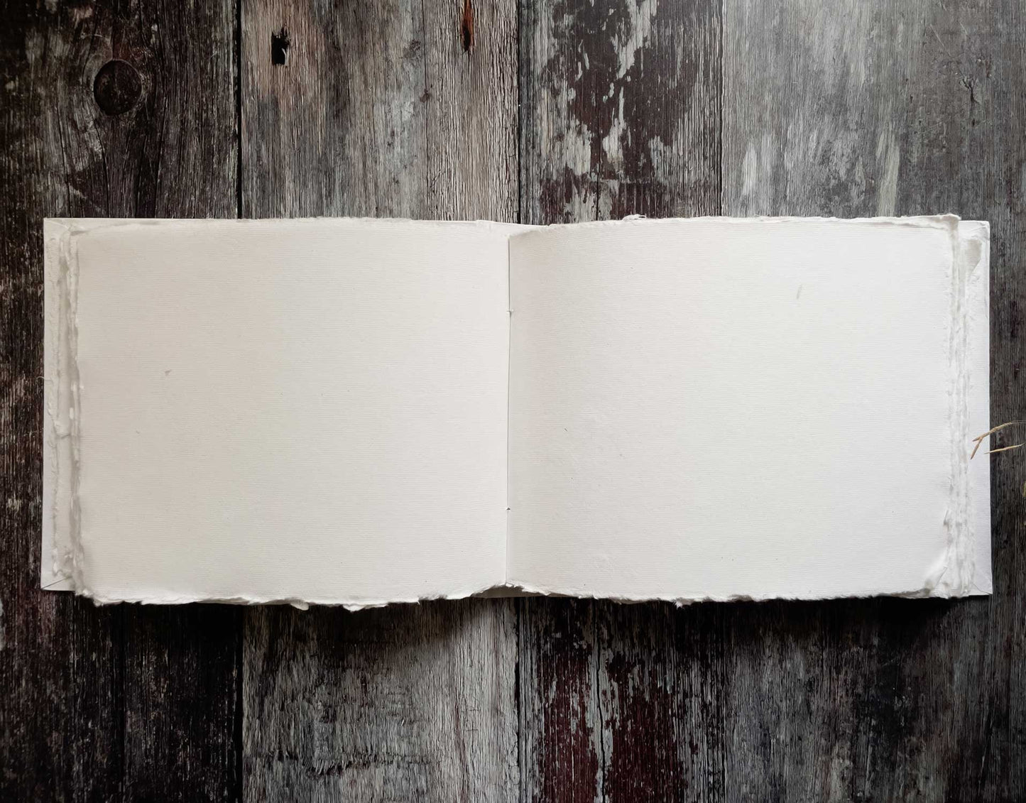 Blank guest book by The Natural Paper Company.  White blank journal with deckle edge pages handmade from recycled cotton rag paper.  100 pages.  Hand bound with a hard cover.  By The Natural Paper Company