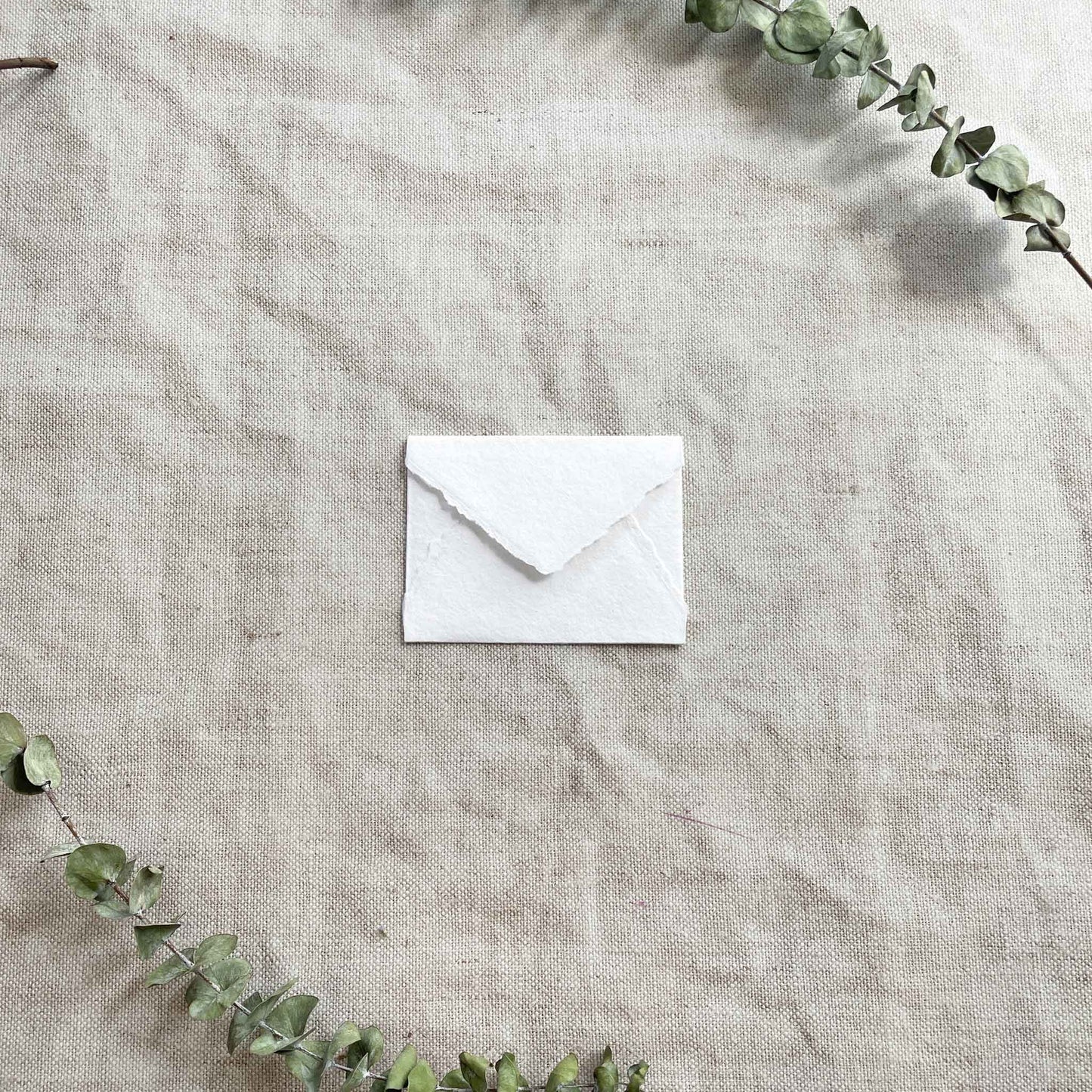 small RSVP envelope made from white handmade cotton rag paper with deckled edges