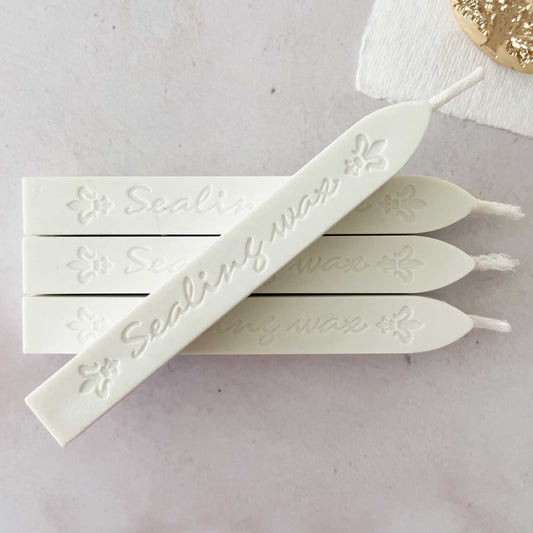 white sealing wax sticks with wick.  Traditional sealing wax in white.  Wax to make stamps and seals.  Perfeect for wedding invtations