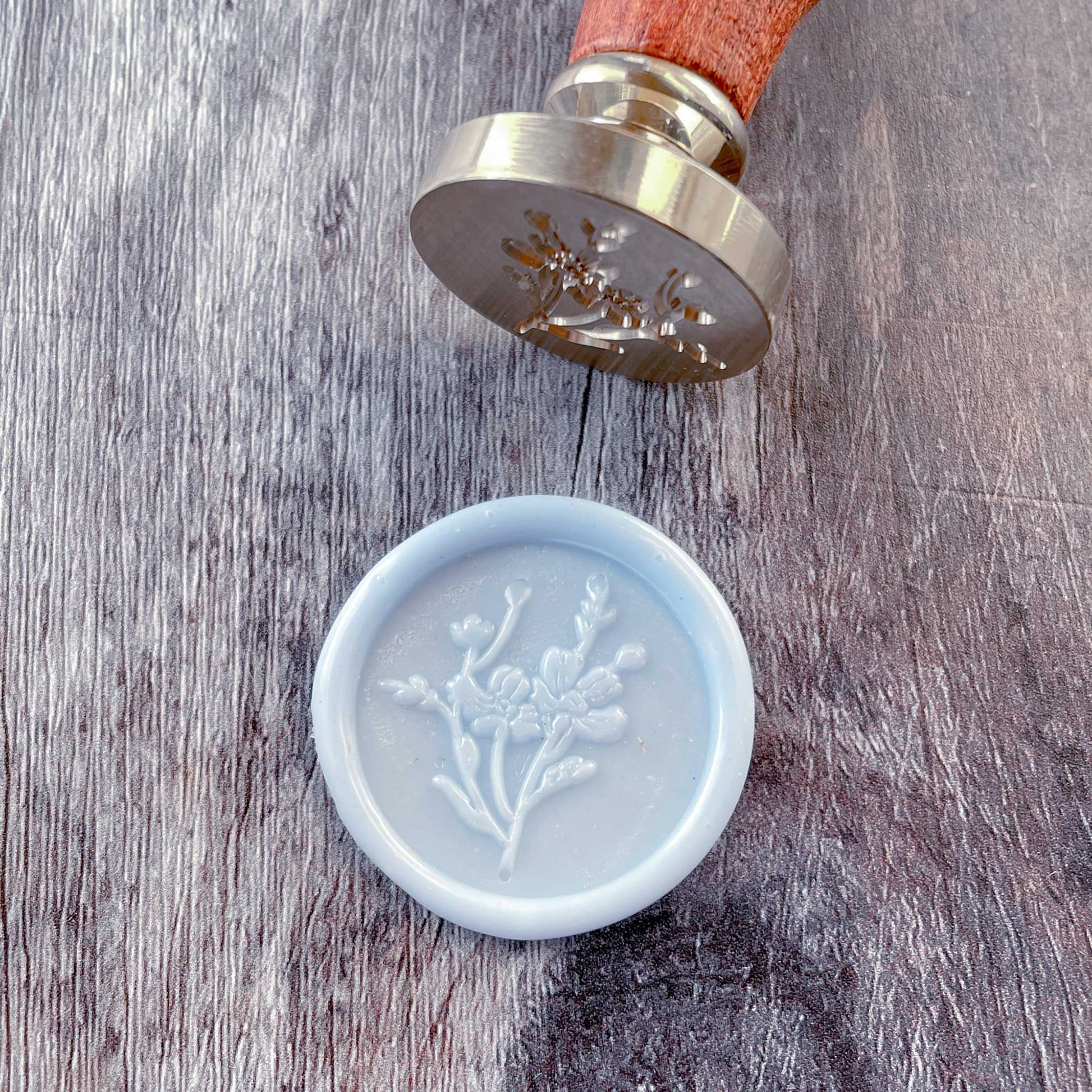 Pale blue wax seal with flower design.  Pretty botanical sealing wax stamp by The Natural Paper COmpany