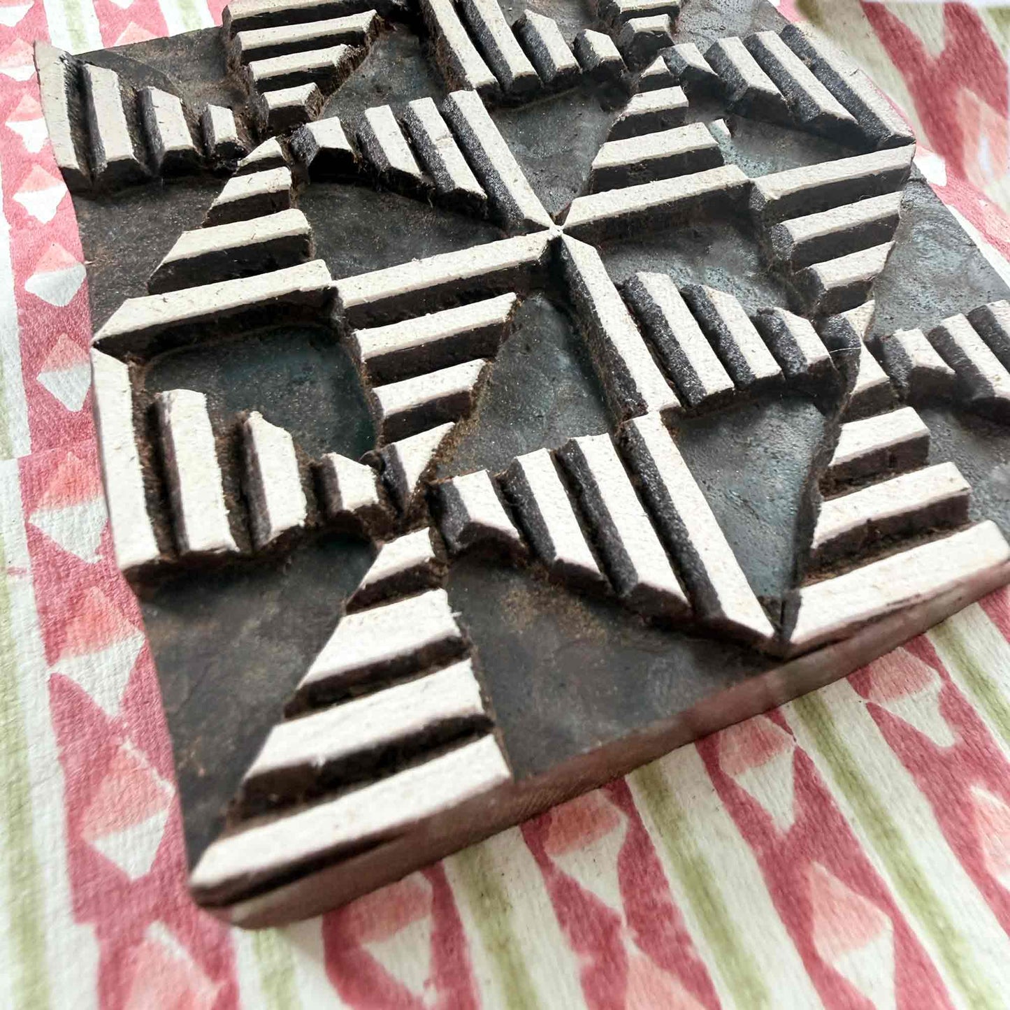 Windmill wooden printing block — close-up side view showing carved texture and depth of geometric segments, handcrafted Indian hardwood stamp on block printed fabric