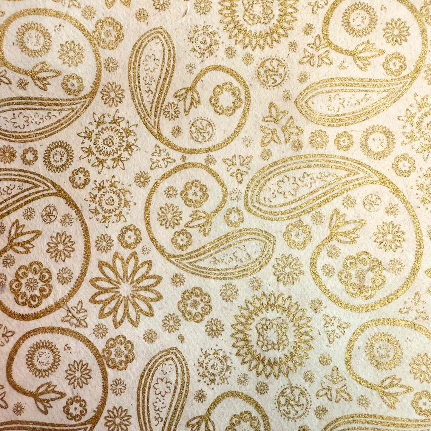 hand made wrapping paper in gold and ivory with an elegant paisley pattern
