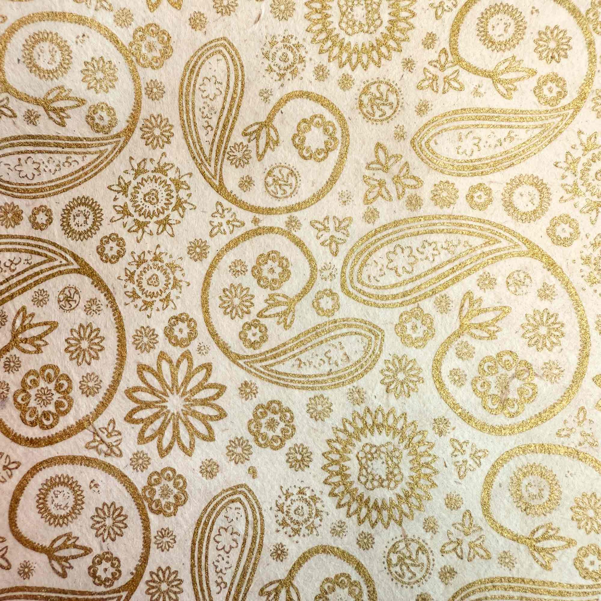 hand made wrapping paper in gold and ivory with an elegant paisley pattern