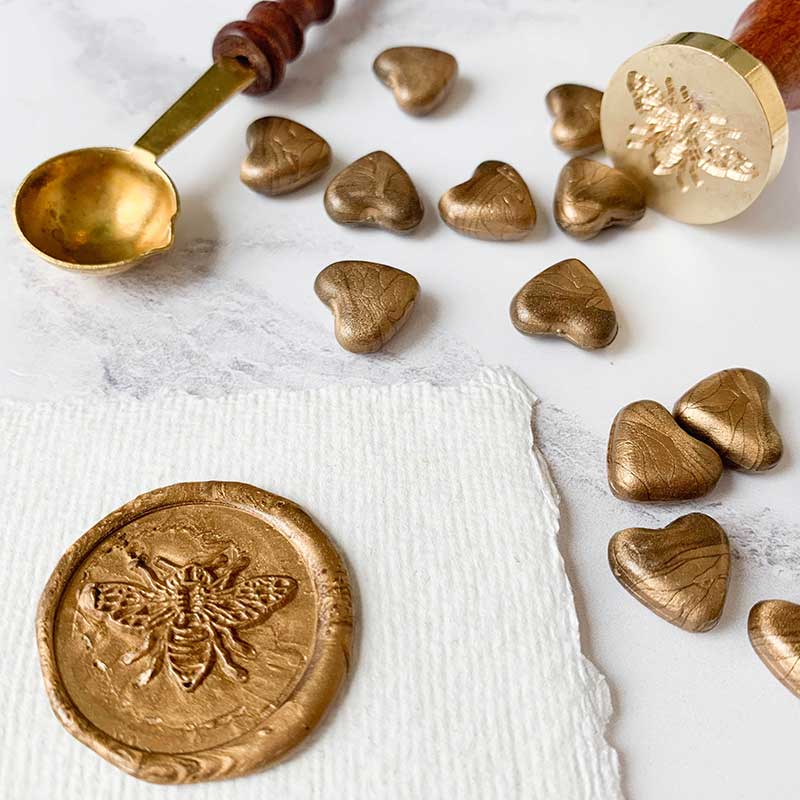 small heart shape wax beads to make wax seals.  Sealing wax beads in warm gold colour