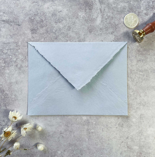 5x7 invitation envelopes made from light blue handmade cotton rag paper.  Recycled envelopes with diamond flap and deckle edge
