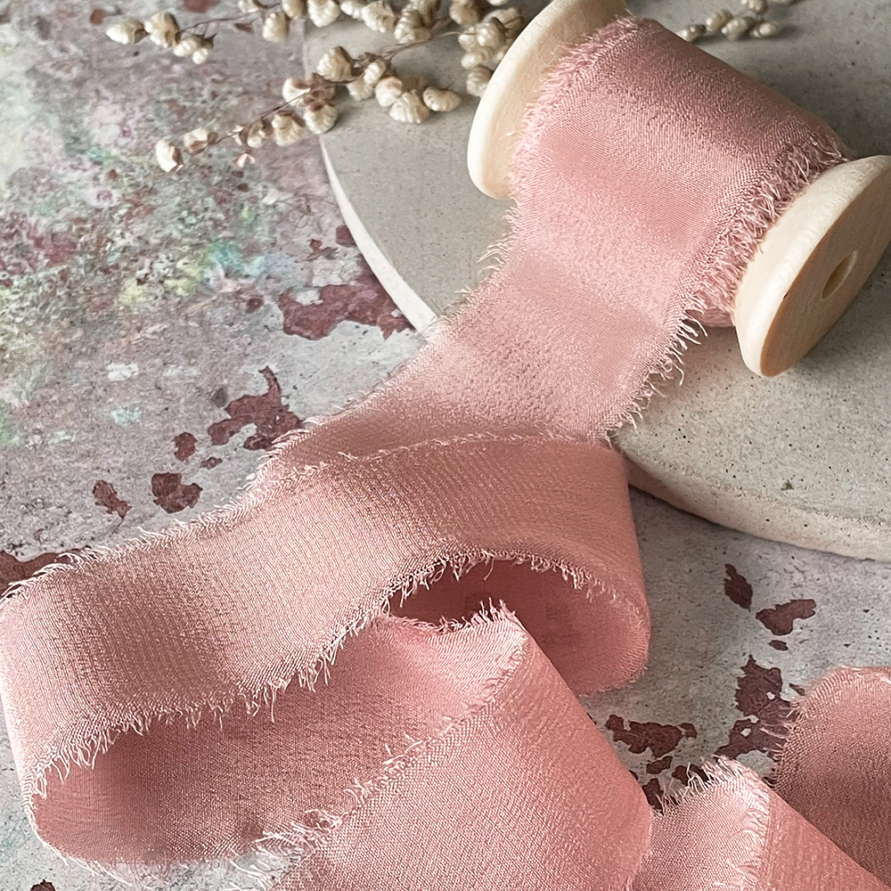 Fine silk ribbon in blush pink.  Frayed edge silk ribbon for crafts.  Perfect for decorating wedding invitations and stationery.  Decorative silk ribbon sold on a wooden reel.  By The Natural Paper Company