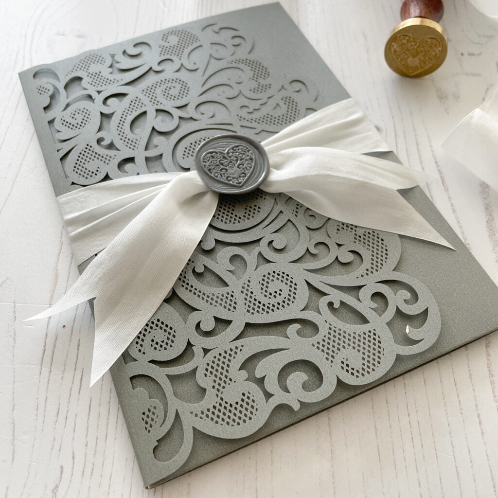 Pretty wedding invitation with white silk ribbon and grey wax seal.  eco friendly Heart design invitation.  By The Natural Paper Company