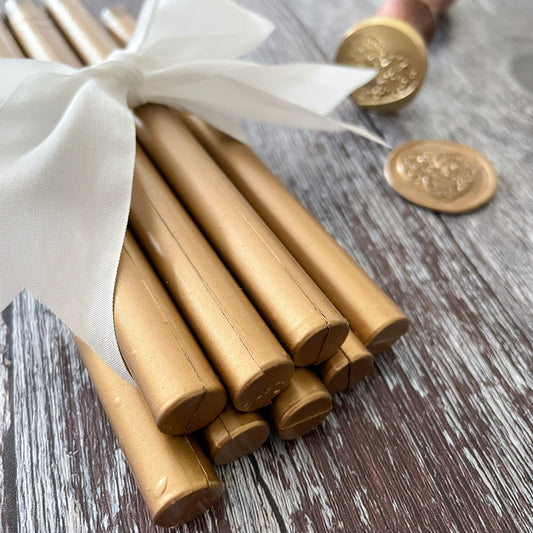 Gold sealing wax sticks.  Sticks of wax for making wax stamps and envelope seals with wax gun or melting spoon.  Metallic Gold sealing wax