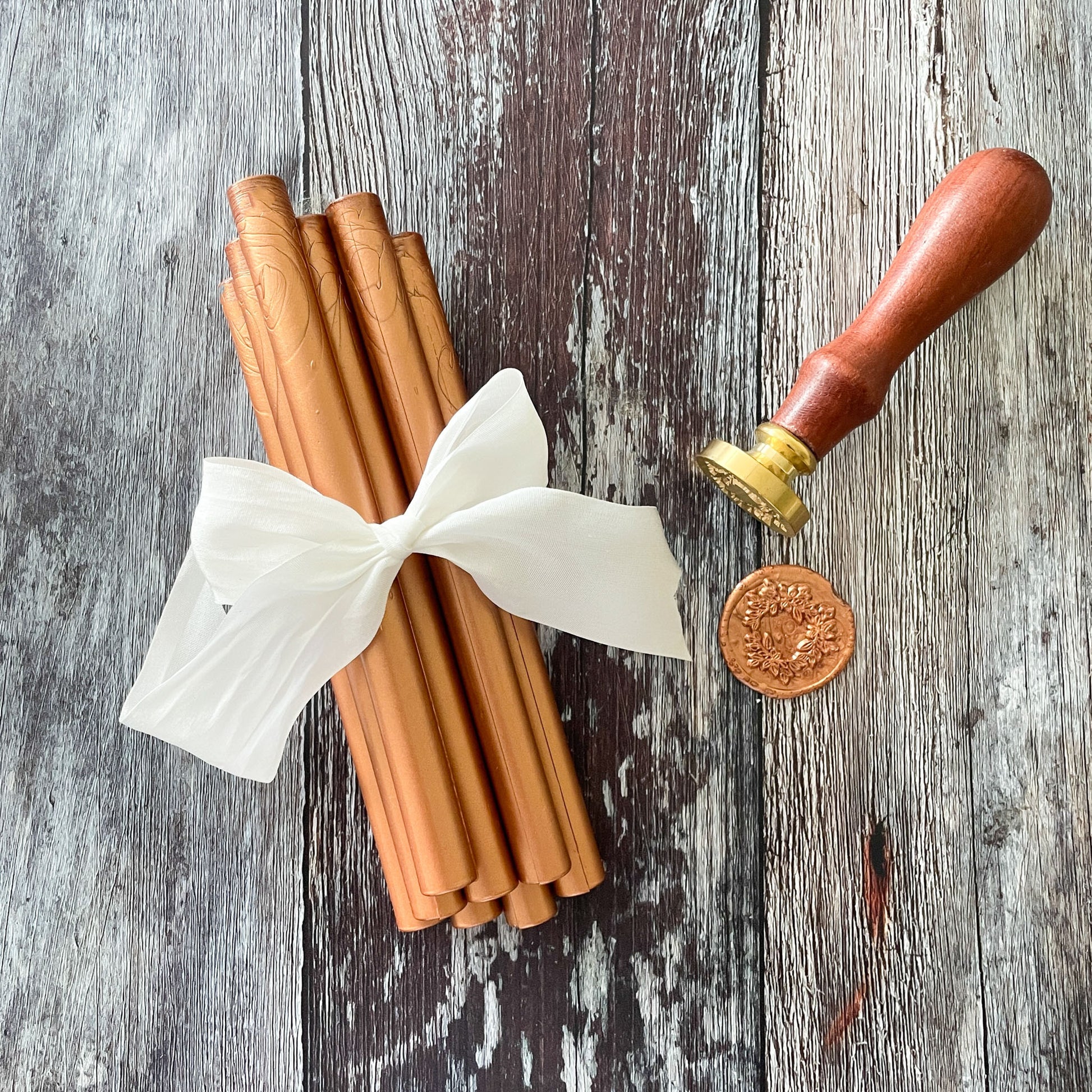 Metallic copper sealing wax sticks to make wax seals.  Eco friendly wax that can be used in a glue gun or with a melting spoon.  Add metallic wax seals to invitations, envelopes, packaging and more.  By The Natural Paper Company
