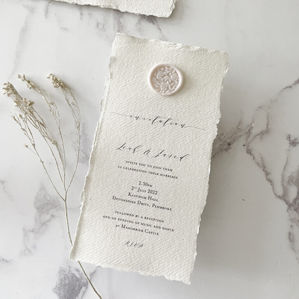 Eco friendly wedding invitation made from handmade recycled paper and an eco friendly wax seal in blush pink.  Easy eco friendly invitation to make yourself.  By The Natural Paper Company