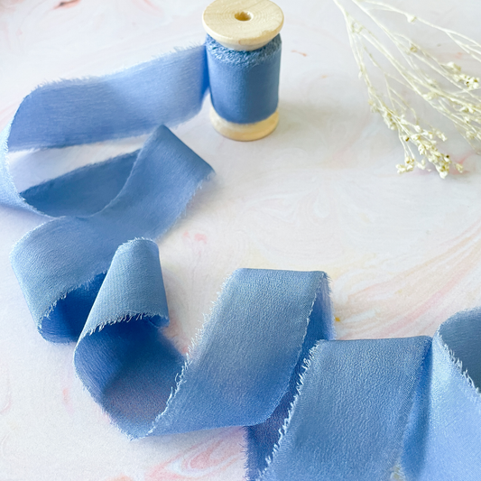 Habotai silk ribbon in airforce blue colour.  Luxury silk ribbon with a frayed edge.  Sold on a pretty wooden reel.  