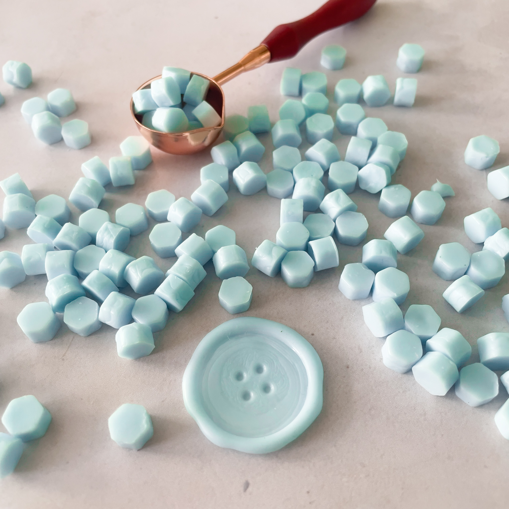 aqua blue colour sealing wax beads.  Small wax beads to make wax seals.  Aquamarine wax to use with a melting spoon
