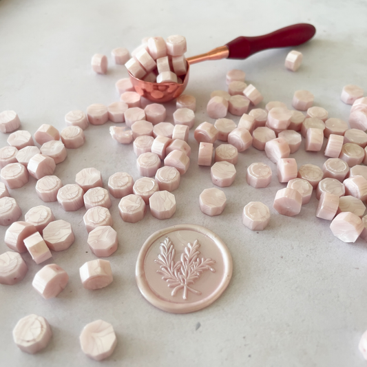 pearlised blush pink sealing wax beads.  Small wax beads to make wax stamps and seals.  Wax beads to use with a melting spoon