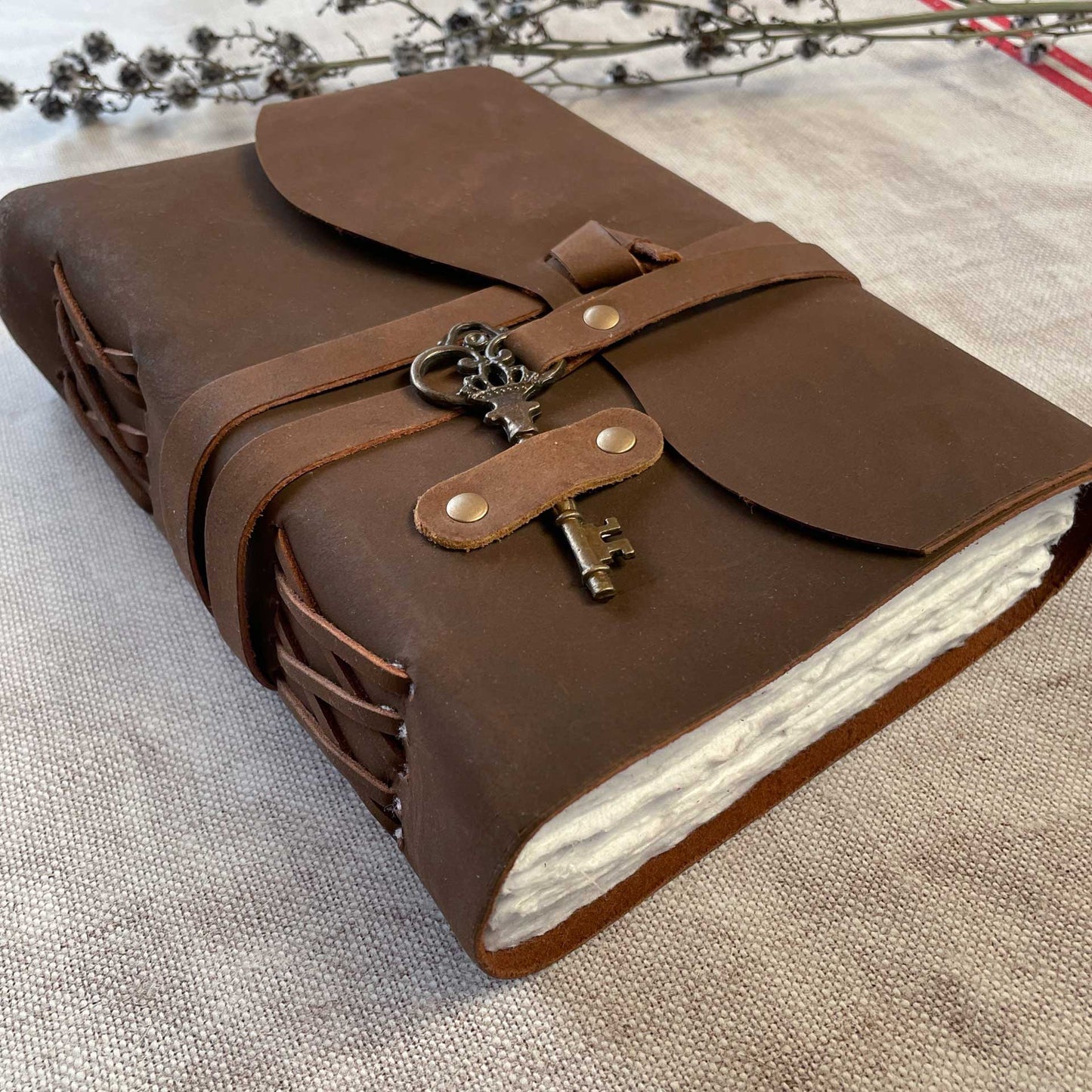 Beautiful hand bound leather notebook with key and loop fastening.  Handmade recycled cotton rag paper pages.  Beatuful rustic leather journal.