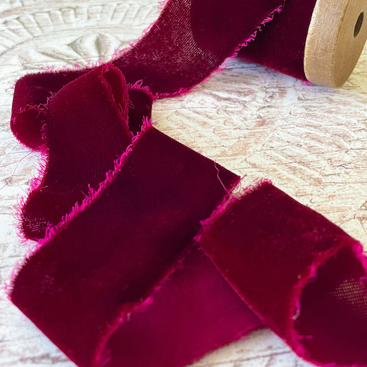burgundy silk velvet ribbon.  Fine velvet ribbon made from silk.  Wine red colour velvet ribbon with a frayed edge