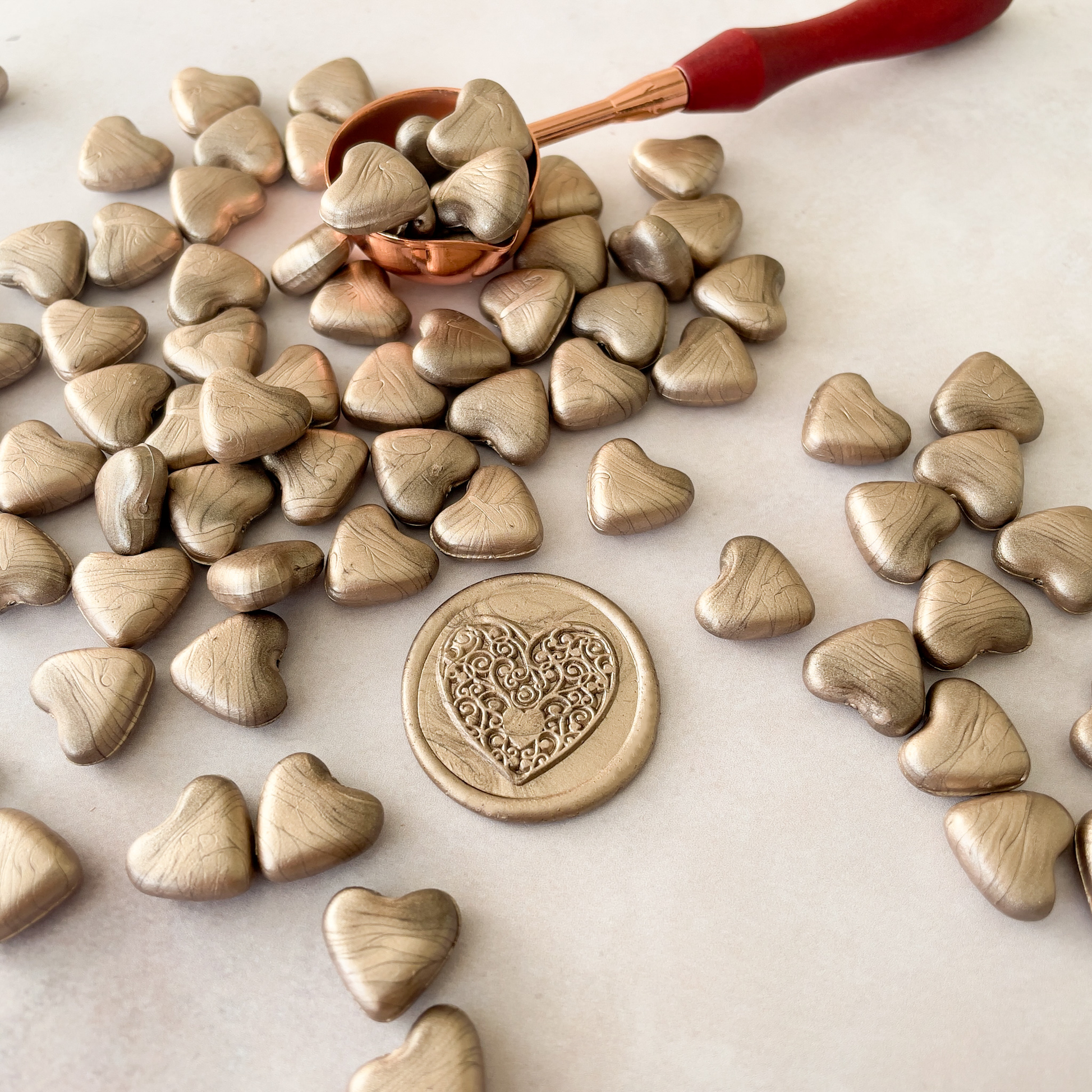sealing wax beads in a champagne gold colour.  Heart shaped wax beads to make stamps and seals