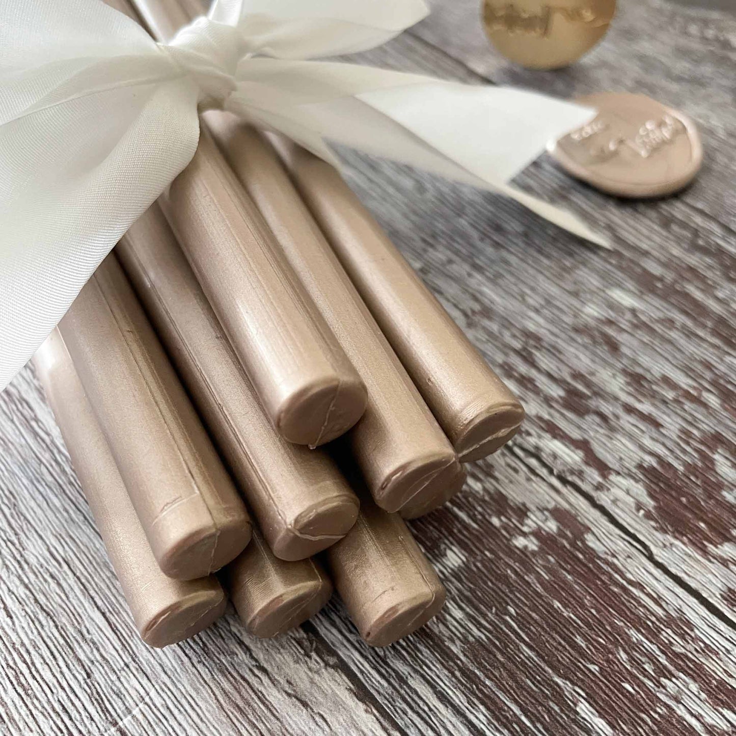 11mm sealing wax sticks By The Natural Paper Company.  Eco friendly wax seal wax in Metallic champagne gold colour.  Suitable for use with a glue gun or melting spoon.  By The Natural Paper Company