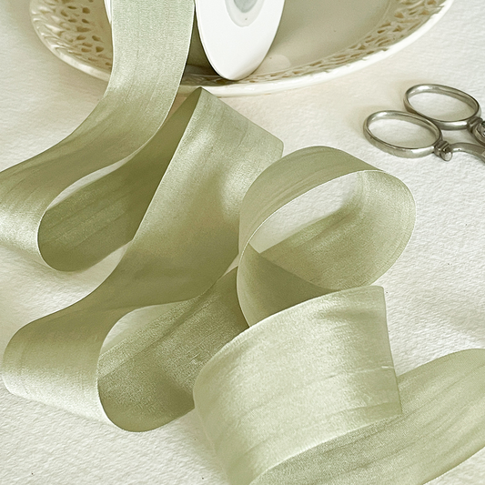 sage green colour silk ribbon.  Fine habotai silk ribbon sold by the meter.  Luxury light sage green ribbon sold by the meter