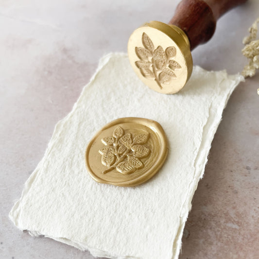 wax seal with leaf design.  Wooden handle stamp to make wacx seals.