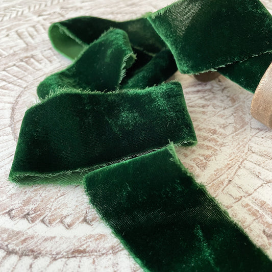 dark green velvet ribbon made from silk.  Luxury fine velvet ribbon with frayed edges.  Luxury velvet ribbon in dark green colour