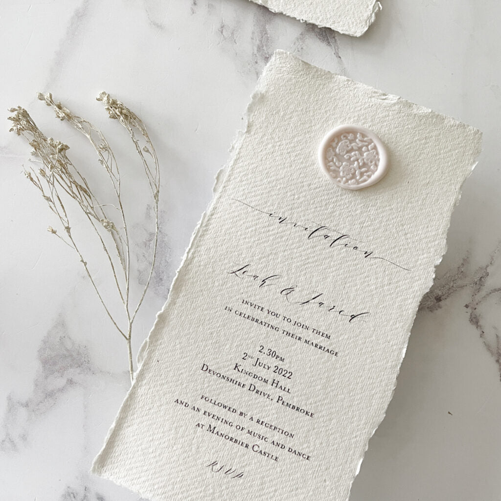 Handmade wedding invitation made using eco friendly materials.  Recycled cotton rag paper, eco friendly sealing wax and a wax seal in blush pink and ivory.  By The Natural Paper Company