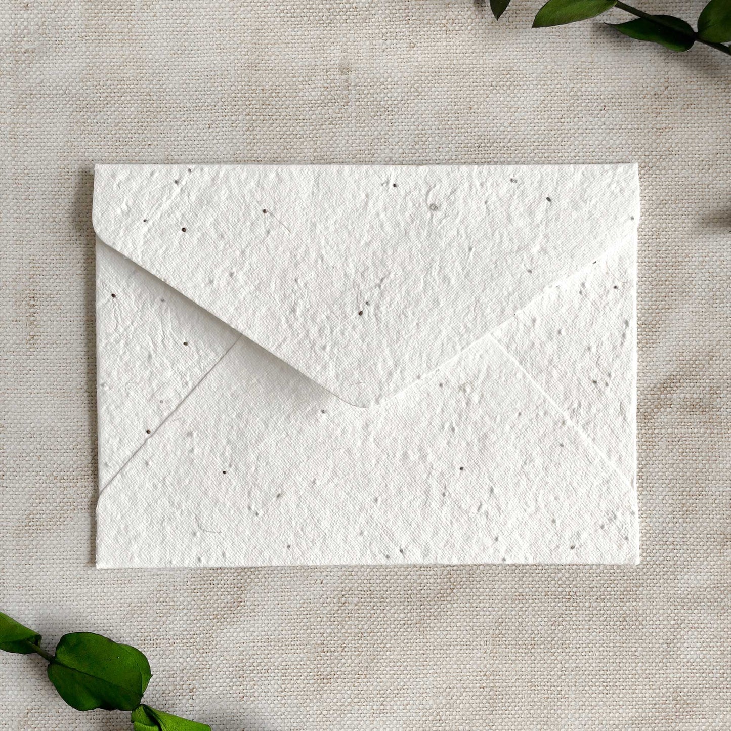 Invitation envelopes you can plant.  Plantable envelopes containing basil seeds.   Handmade envelopes made from seeded paper.  By The Natural Paper Company