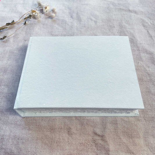 Handmade paper journal with light blue cover.  Blank book made from recycled cotton rag paper.  A5 landscape format.  100 pages