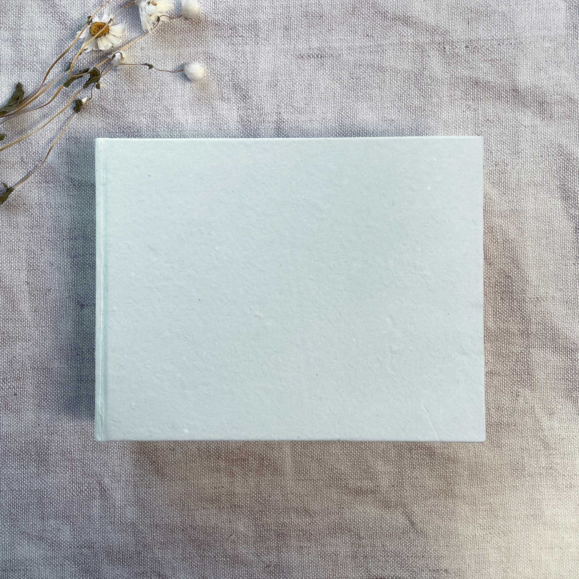 handmade journal made from recycled paper.  Blank book in light blue with white handmade cotton rag paper pages.  Hand bound.  Perfect to decorate as a guest book, journal, notepad or artist sketch page.  Light blue cover