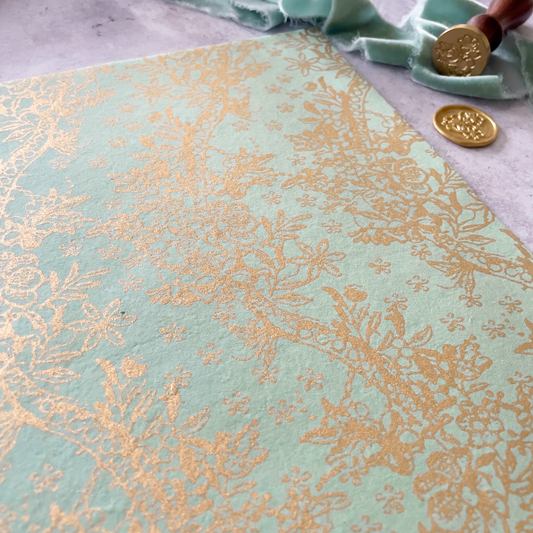 light green and gold patterned paper made from recycled cotton.  Pale green and gold floral patterned A4 paper
