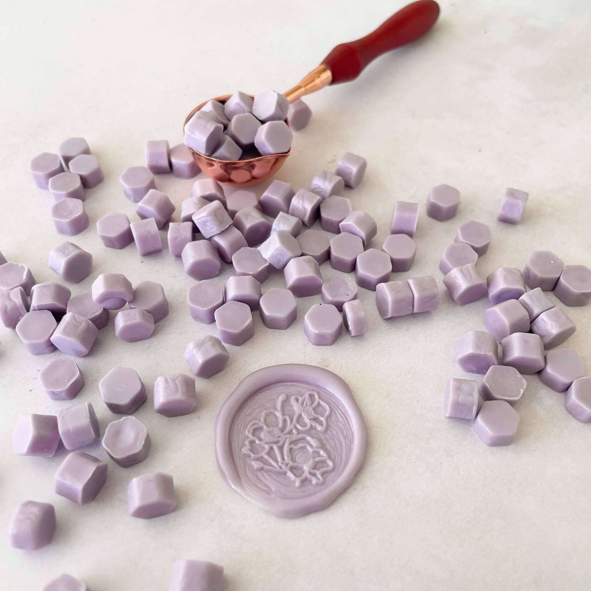 sealing wax beads in pastel lilac colour.  Wax beads to melt with a melting spoon to make wax seals and wax stamps