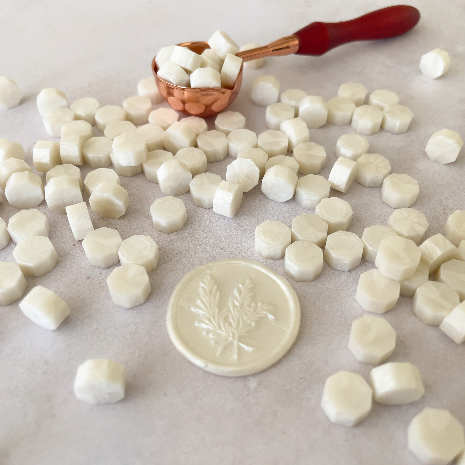pearlised ivory sealing wax beads.  Small beads made from wax.  Melt in a melting spoon to make wax stamps and seals