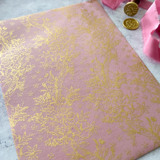 pink recycled paper with floral gold pattern.  Decorative paper in pink and gold.  Made from recycled cotton.  