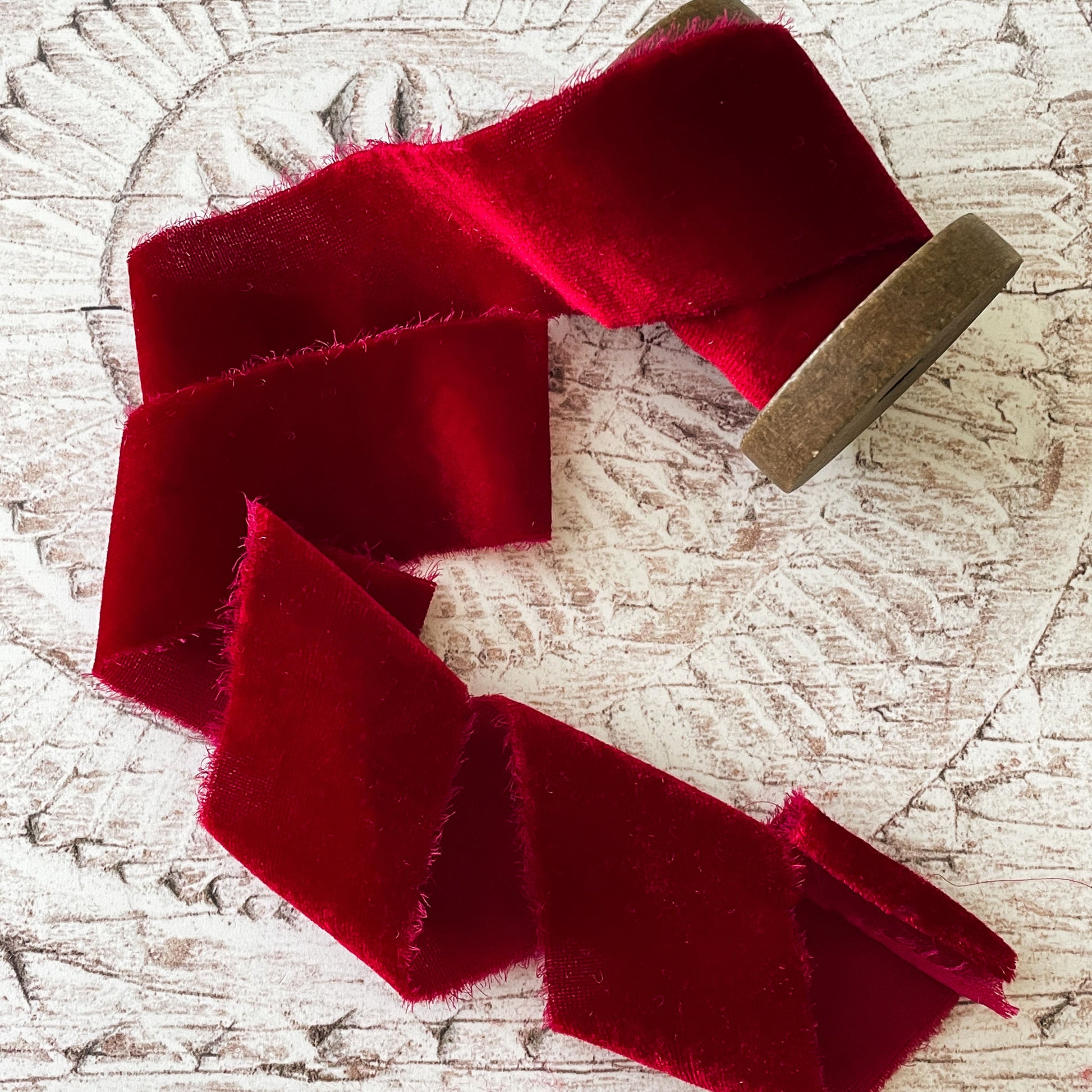 red silk velvet ribbon.  Bright red velvet ribbon made from silk.  Luxury fine velvet ribbon with raw edge