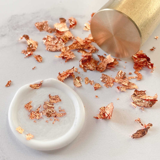 rose gold leaf flakes to decorate wax stamps and seals.  Copper colour metallic flakes