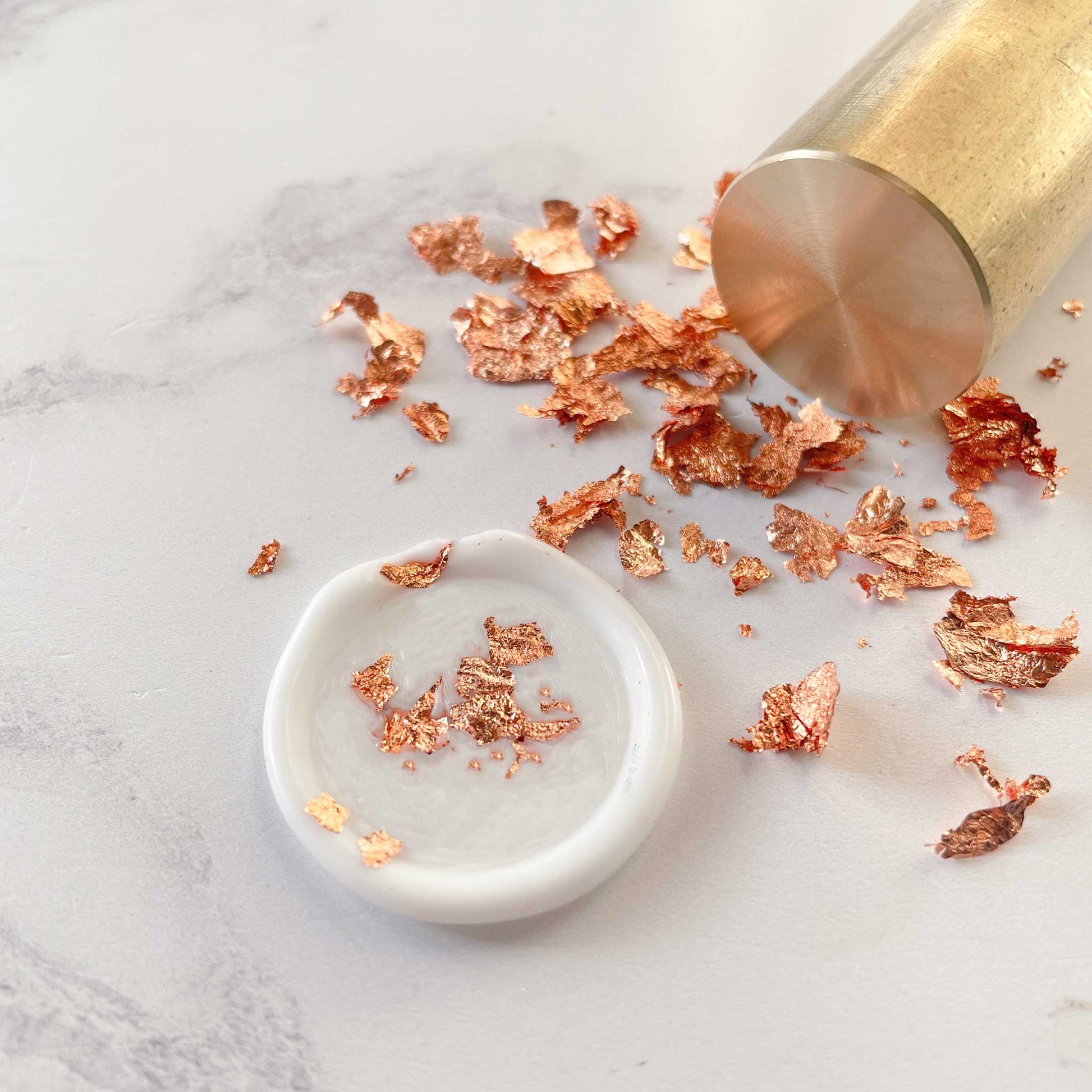 Rose gold leaf flakes for decorating wax seals.  Add metallic decoration to your sealing wax stamps.  By The Natural Paper Company