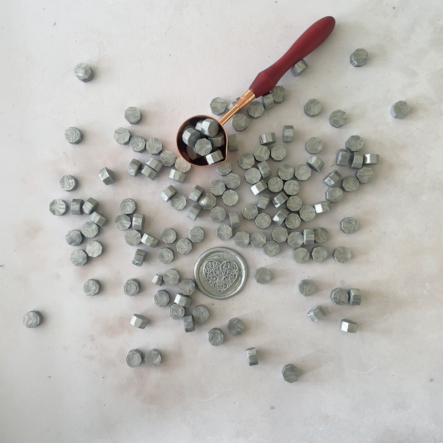 small metallic silver wax beads to make wax stamps and seals.  Wax beads to melt with a melting spoon.  