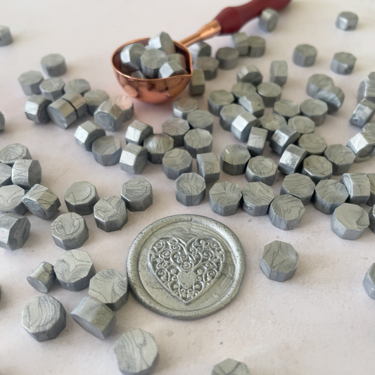 metallic silver sealing wax beads.  Small hexagon shaped wax beads for making wax stamps and seals.  Traditional wax seal supplies in metallic silver colour