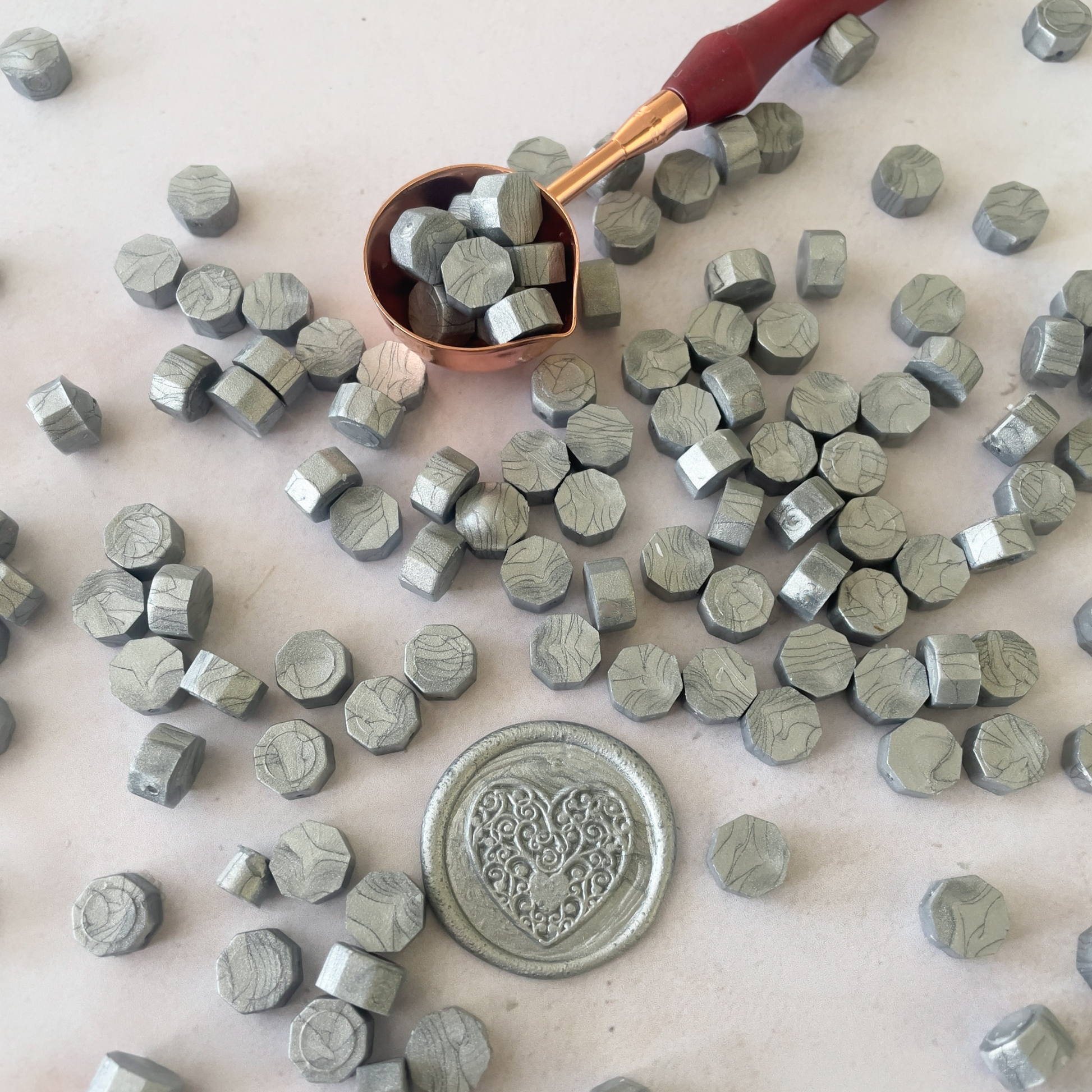 silver sealing wax beads to make wax stamps and seals.  Metallic silver wax beads to melt with a melting spoon