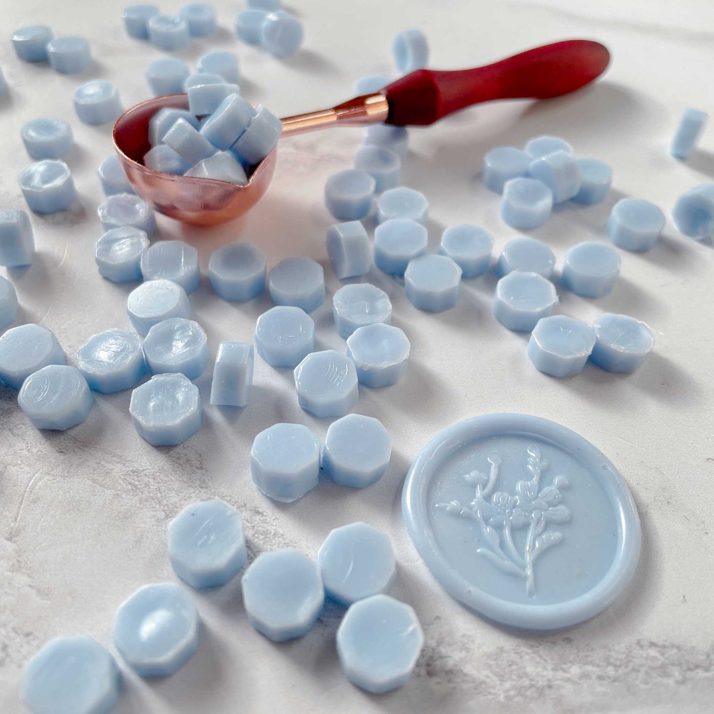 Light blue sealing wax beads.  Small beads of wax to make wax seals and stamps.  Traditional wax seal and envelope seal supplies in sky blue